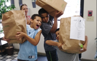 children holding grocery bags