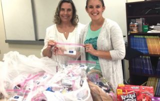 two women packing baggies