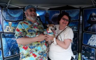 happy man and woman with their dog